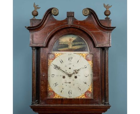 An early 19th century eight-day mahogany longcase clock, with reeded pilasters and shaped door to the trunk, the hood with sw