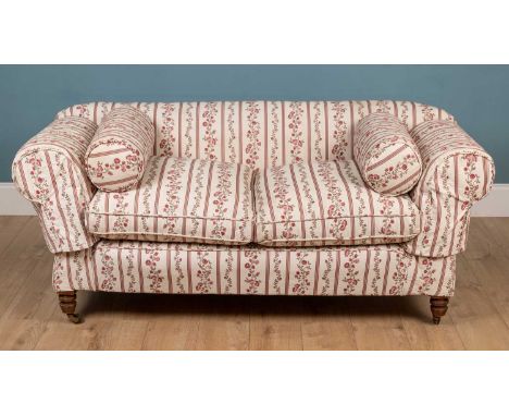 A late Victorian or Edwardian small Chesterfield sofa with drop ends, turned front legs and brass casters164cm wise x 90cm de