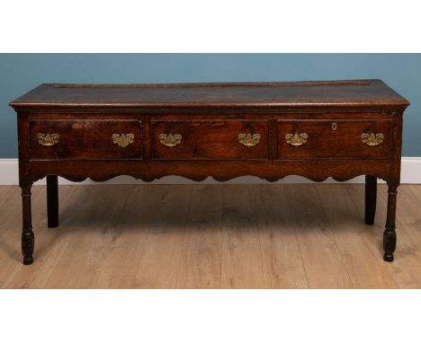 A Georgian oak dresser base with three short drawers180cm wide x 48cm deep x 80cm highSurface scratches and marks. Signs of o