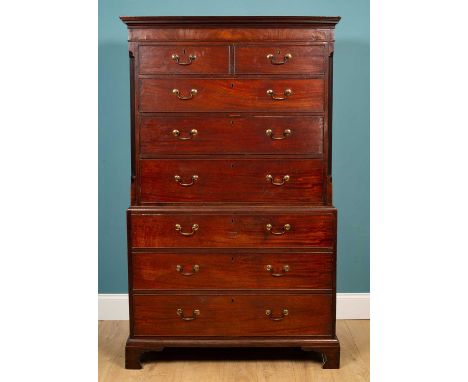 A George III mahogany chest on chest, the upper section with two short and three long drawers flanked by fluted canted angles