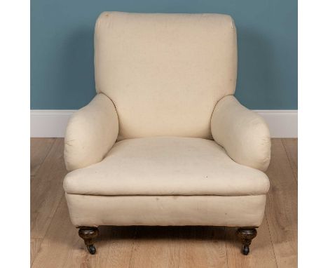 An old deep armchair in the Howard style, with turned front legs and ceramic casters84cm wide x 110cm deep x 78cm highThe uph