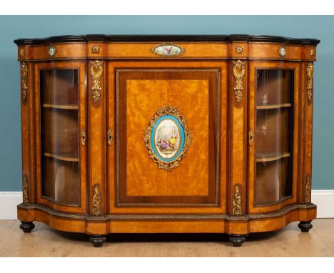  A Victorian satinwood and walnut banded credenza or side cabinet with ormolu mounts and inset with continental porcelain pan