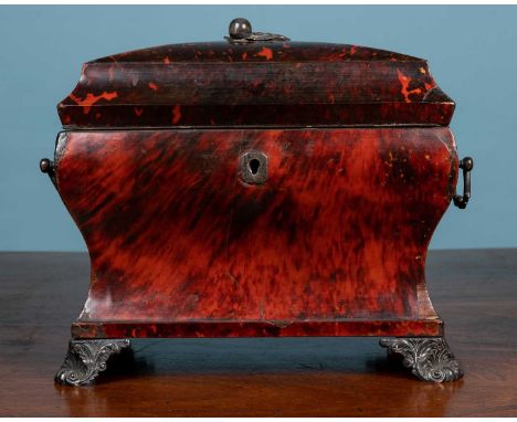 A red tortoiseshell tea caddy, with silver mounted detailed handles on either side, foliate detail on the top and legs27cm wi