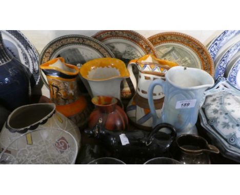 A Tray of Ceramics to Include Jackfield Cow Creamer, Vintage Jugs, Dickens and Cries of London Plates Etc