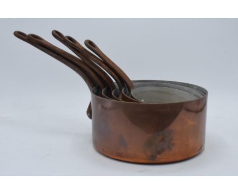A collection of 5 vintage graduated copper pans with metal handles (5).  