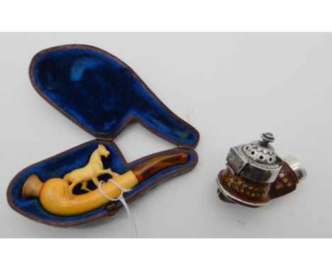 A lot comprising a cased pipe with horse carving and amber stem, 10.3cm long and a pipe bowl (2) Condition Report: Available 