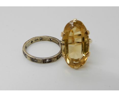 A yellow metal citrine set ring, size F1/2, together with a 9ct gold clear gem set eternity ring, size P, combined weight 6.8