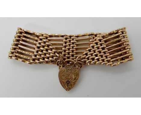A 9ct gold wide gate bracelet, length 19cm, width 2.7cm, with heart shaped clasp, weight 33.4gms Condition Report: Available 