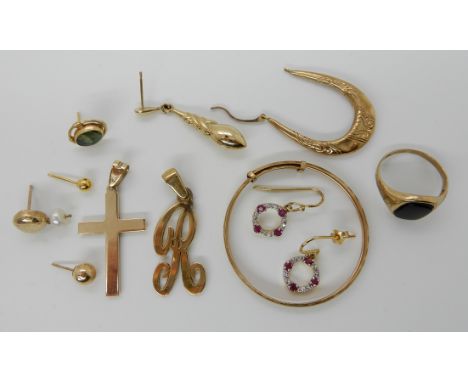 A 9ct gold baby's bangle, 9ct cross, 9ct signet ring, and a collection of odd gold and yellow metal earrings and other items,