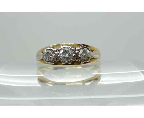 A bright yellow metal three stone diamond ring size T, diamond content estimated approx 0.25cts, weight 3.3gms Condition Repo