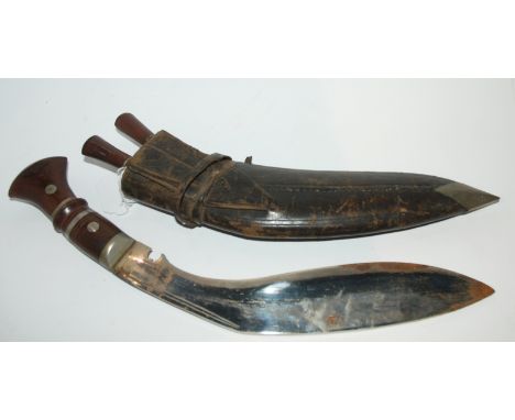 A Kukri in leather scabbard Condition Report: Available upon request