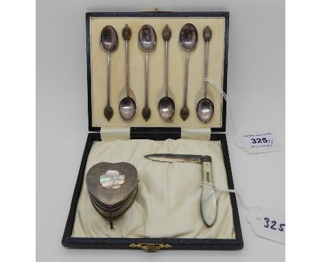 A cased set of six silver coffee bean spoons, Birmingham 1946, a silver and mother of pearl fruit knife and a heart shaped si