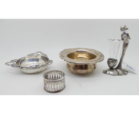 A lot comprising a small silver bowl, a white metal dish and napkin ring and a white metal and glass figural posy holder (4) 