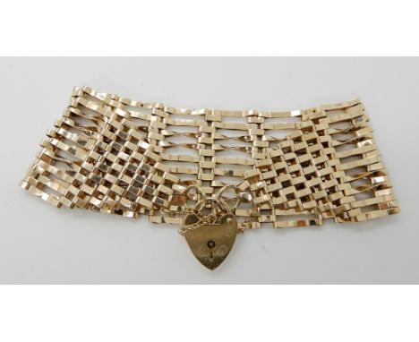A 9ct gold wide gate bracelet with heart shaped clasp, length 20cm width 3.5cm, weight 24.5gms Condition Report: Available up