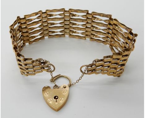 A 9ct gold wide gate bracelet with heart shaped clasp, length 18cm, weight 15.4gms Condition Report: Available upon request
