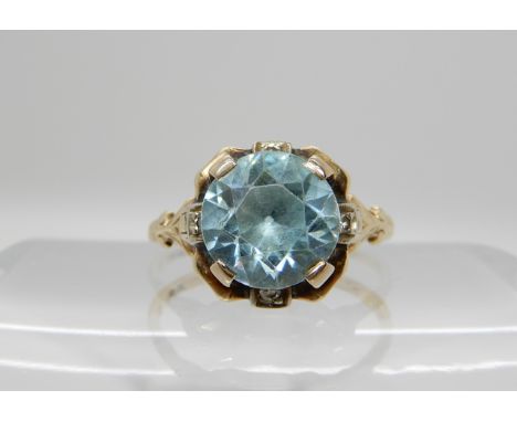 A 14k gold blue zircon and diamond accent ring, size O1/2, weight 3.1gms Condition Report: Available upon request