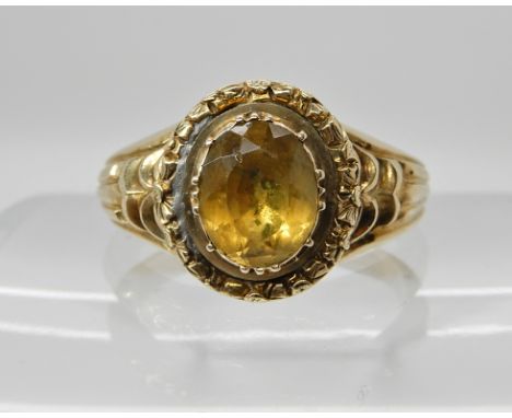 An early Victorian style citrine ring with reeded shoulders and engraving surrounding the foiled back citrine. Finger size T,