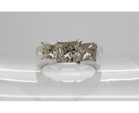 An 18ct white gold three stone princess cut diamond ring, central diamond estimated approx 0.66cts and flanked by two at 0.42