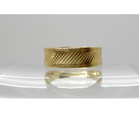 An 18ct gold engraved pattern wedding ring, size N/12, weight 4.1gms Condition Report: Available upon request