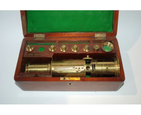 A Victorian lacquered brass barrel microscope by Lennie of Edinburgh in fitted teak box with a selection of lenses and optics