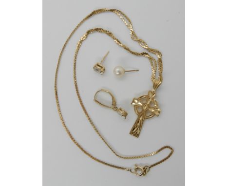 A 14k gold Celtic cross with a 14k gold double snake chain and three odd 14k gold earrings, total weight 7.7gms Condition Rep