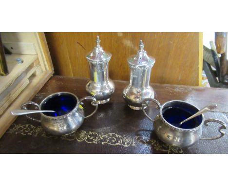 A silver four piece cruet set