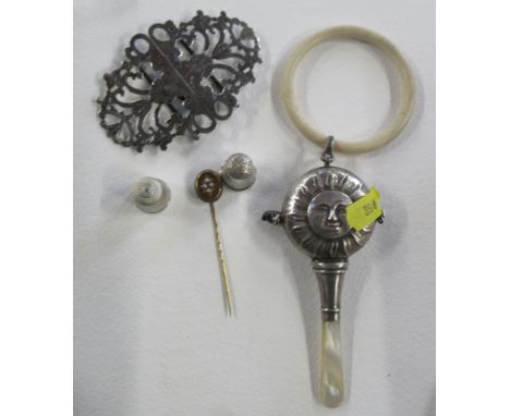 A silver babies teether, together with a silver buckle, a stick pin and two thimbles