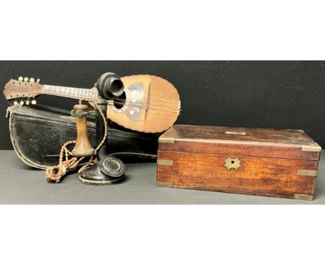 A candlestick telephone, c.1920; an early 20th century mandolin, labelled Giuseppi Casini, cased; a Victorian mahogany writin