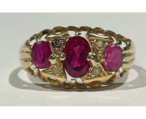 An Antique Synthetic Ruby and Diamond Ring;the ring is set with three oval brilliant cut Synthetic Rubies, the centre one mea