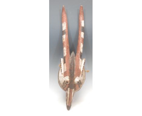 Tribal Art - a Mossi antelope mask, decorated with abstract motifs in kaolin, and red and brown earth pigments, 56cm long, Bu