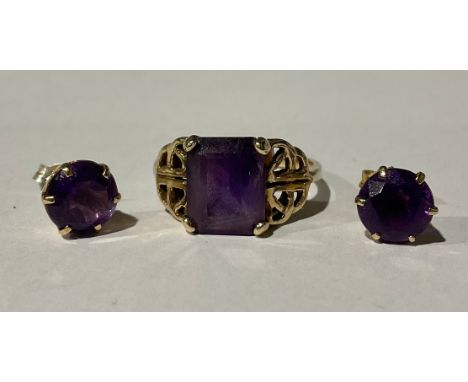 A 9ct Gold Amethyst ring and a pair of 9ct Gold Amethyst stud earrings;the amethyst ring is set with a rectangular step cut a