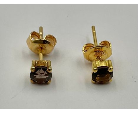 A pair of 14ct Gold Smoky Quartz Stud Earrings;each earring is set with an approx. 4mm diameter smoky quartz,each butterfly b