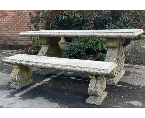 A composite simulated stone garden table, 76cm high, 191cm long, 94cm wide; a conforming bench, 43cm high, 153cm wide, 42cm d