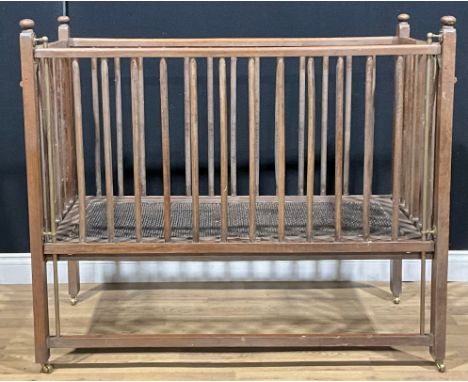 An Arts &amp; Crafts design oak folding cot or crib, 105cm high, 121cm long, 58.5cm wide