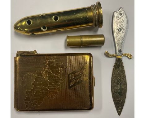 Militaria - A late 1940s Germany British Zone cigarette case/lighter; a shell; a Trench Art paper knife, inscribed ‘World War