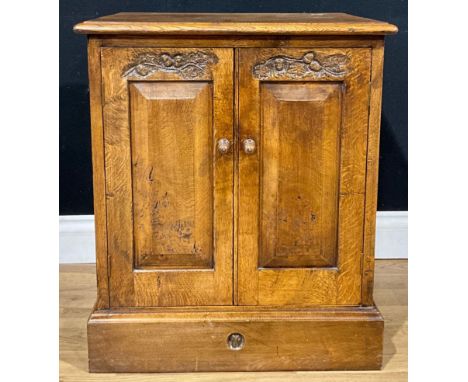 An oak side cabinet, of small proportions, in the manner of Terry ‘Ram Man’ Harrington, the pair of raised and fielded panel 
