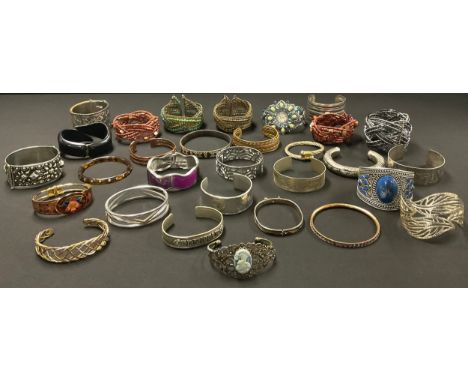 A selection of Thirty Costume Jewellery Banglesto include; a "950" stamped bangle and an "ALPACCA" stamped bangle