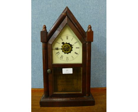 A 19th Century American Waterbury Clock Co. rosewood shelf clock 