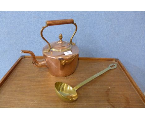 A Victorian copper kettle and a large brass ladle 