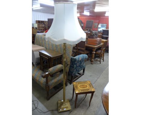 A brass Corinthian column standard lamp and an Italian musical table 