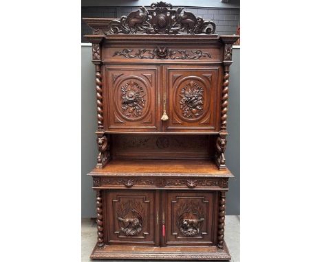 An antique French hunting chest, the revolt carried by carved lions. The richly carved crest with griffins On the upper doors