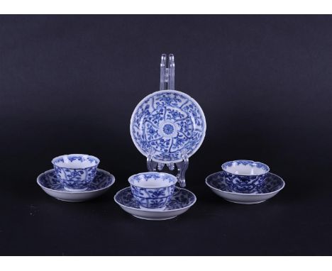 Three small model porcelain cups and four saucers with rich floral decoration in meandering beds. China Kanxi.Diam. 7.5 H 3.5