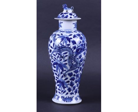 A porcelain baluster vase decorated with dragons, marked Kangxi. China, 19th century.H. 28 cm.