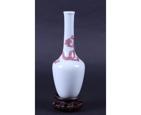 A porcelain pipe vase with Iron red decoration of a dragon, marked Kangxi. China, 19/20th century.H. 21 cm.