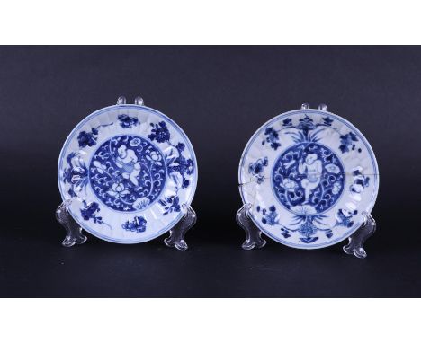 Two porcelain plates in the cut-out technique, decor of a playing boy with a flower guirlade in the hands. China, Kanxi.Diam.