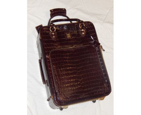 Aspinal of London, A brown faux croc roller bag.