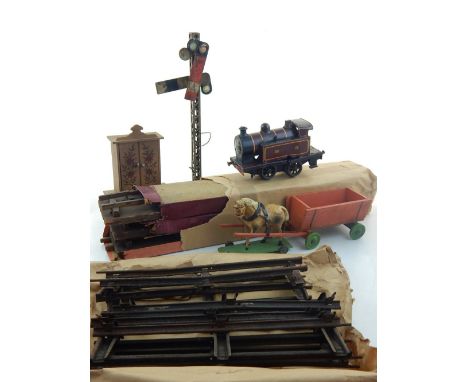 An early 20th century 0-4-0 tinplate clockwork O gauge tank engine together with a signal track and sundries.