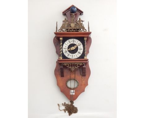 A 20th century Dutch bracket clock, the applied brass chapter ring with Roman numerals, flanked by brass barley twist columns