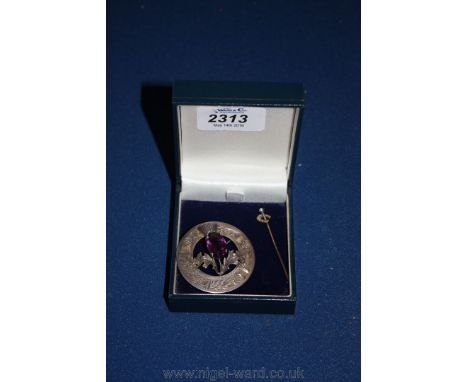 A gold and pearl Horseshoe Stickpin and a Silver and amethyst Thistle Brooch. 