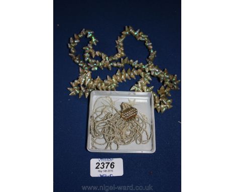 A Seed Pearl Choker with gold and seed pearl clasp and a shell Necklace.